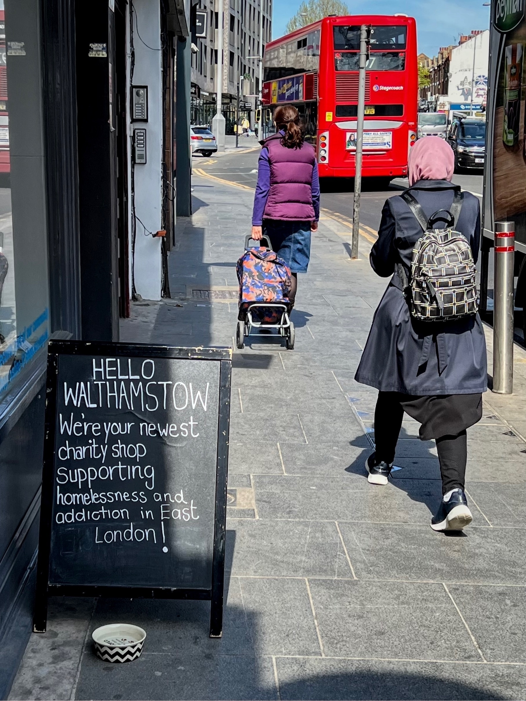 Shop sign saying "we're your bewest charity shop supporting addiction and homelessness".